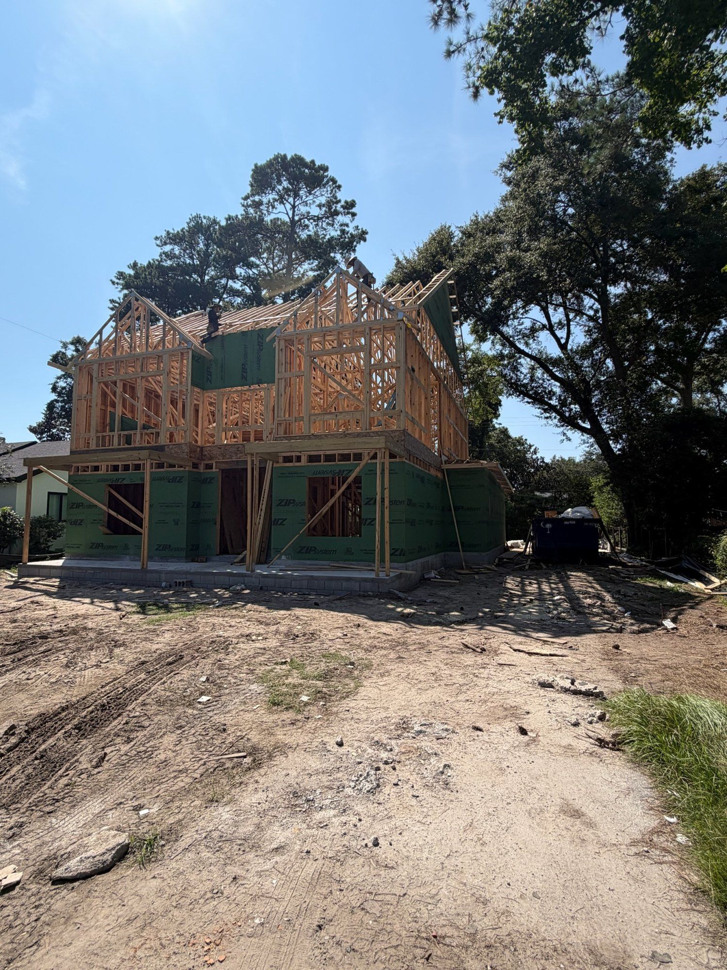 Two-story framing and roof trusses going up on the new home