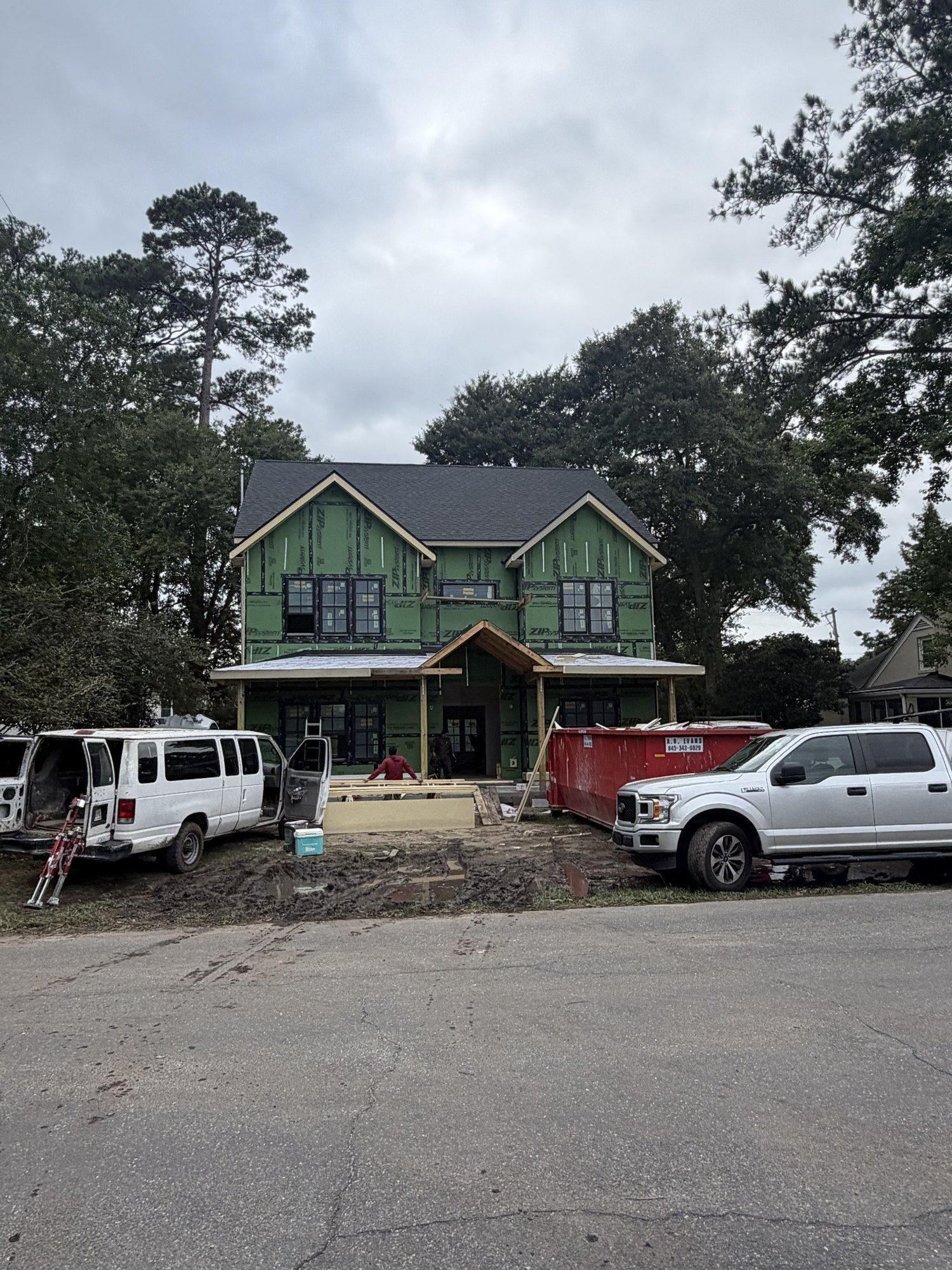 Front of the new home with roof, windows and front porch framing installed