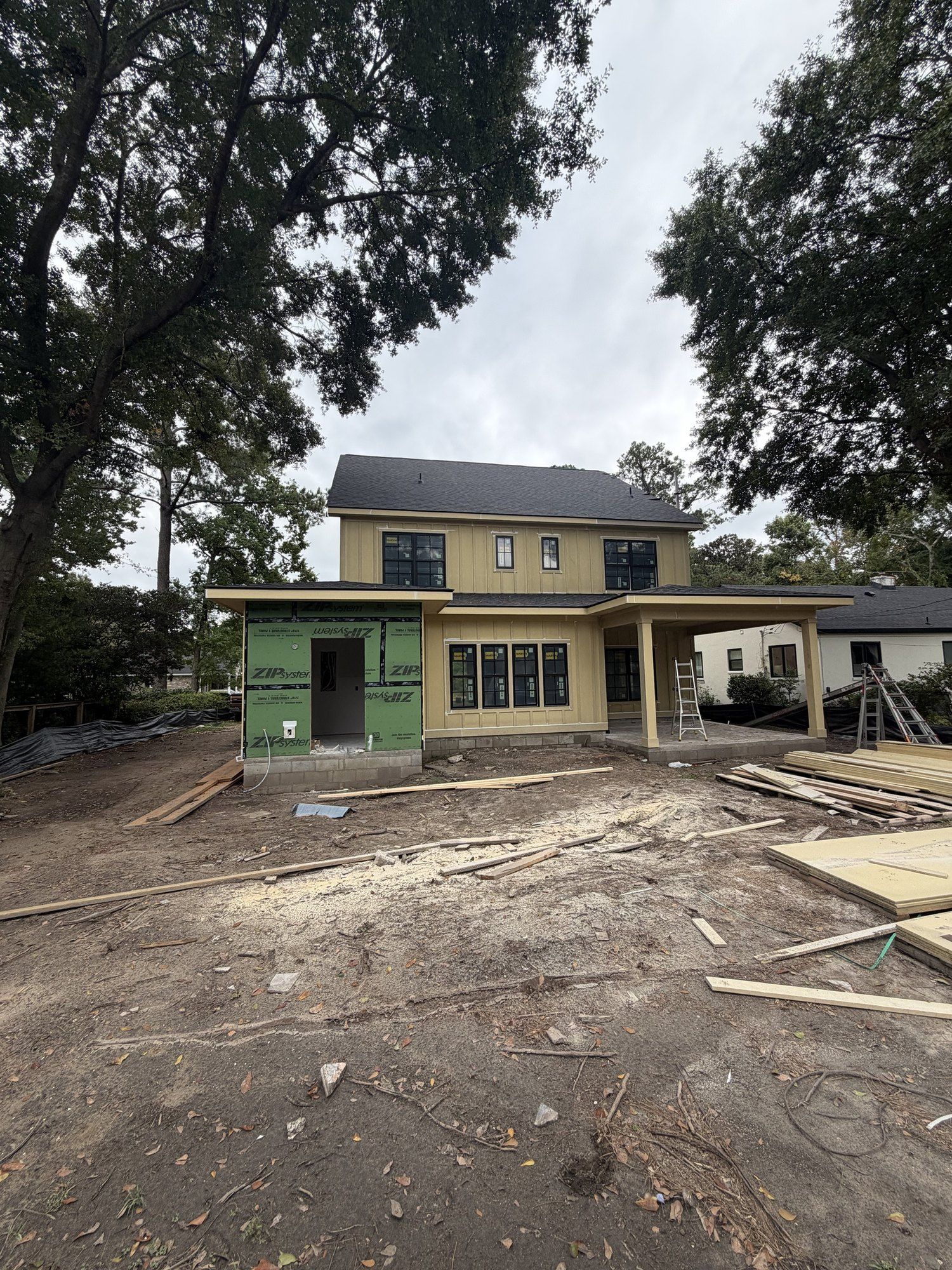 Rear of the new home with board-and-batten siding and covered porch