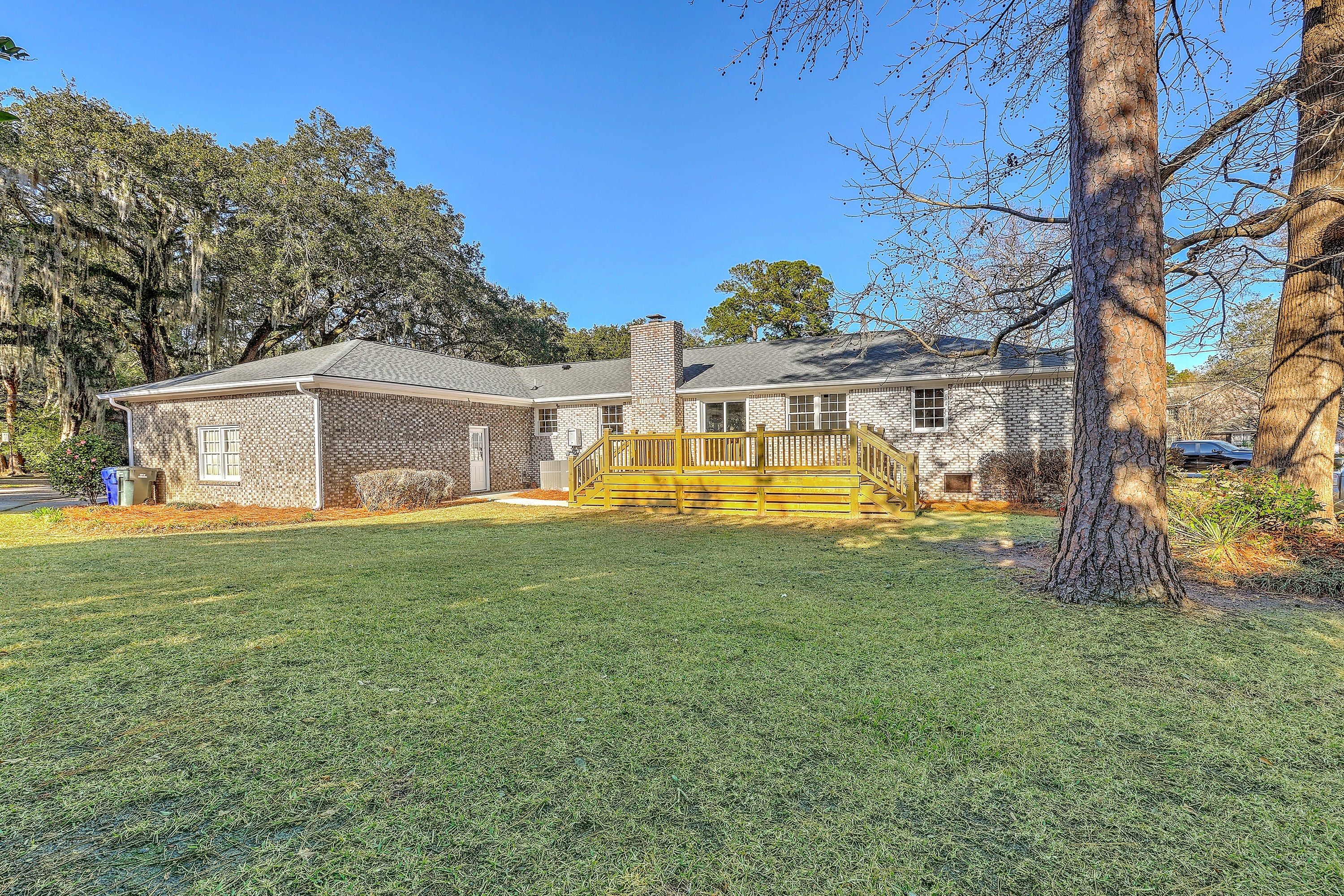 Rear of the home with a new oversized deck and expansive backyard